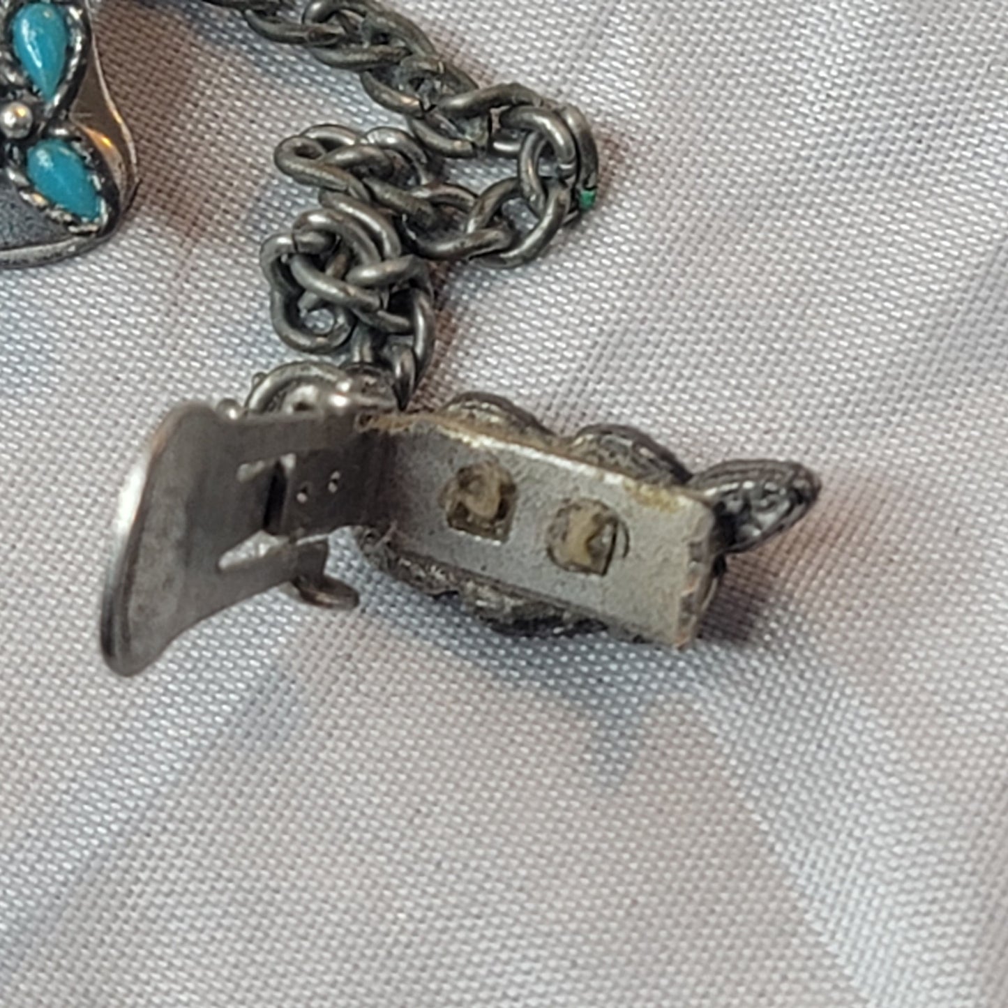 Faux turquoise  silvertone sweater double clip missing one stone