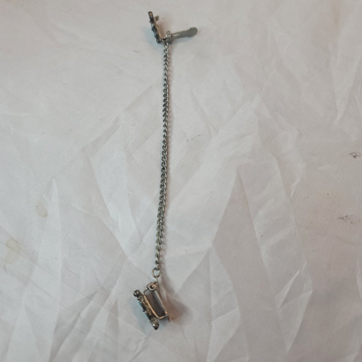 Faux turquoise  silvertone sweater double clip missing one stone