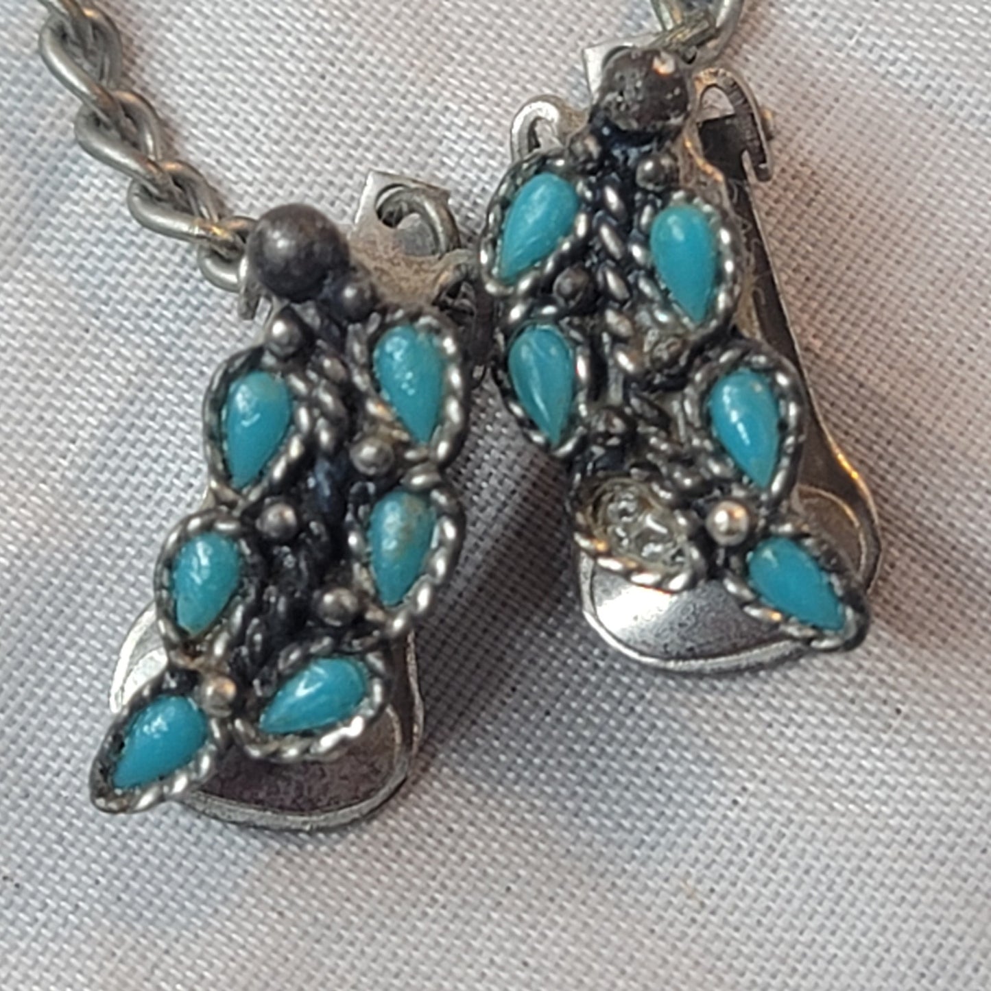Faux turquoise  silvertone sweater double clip missing one stone