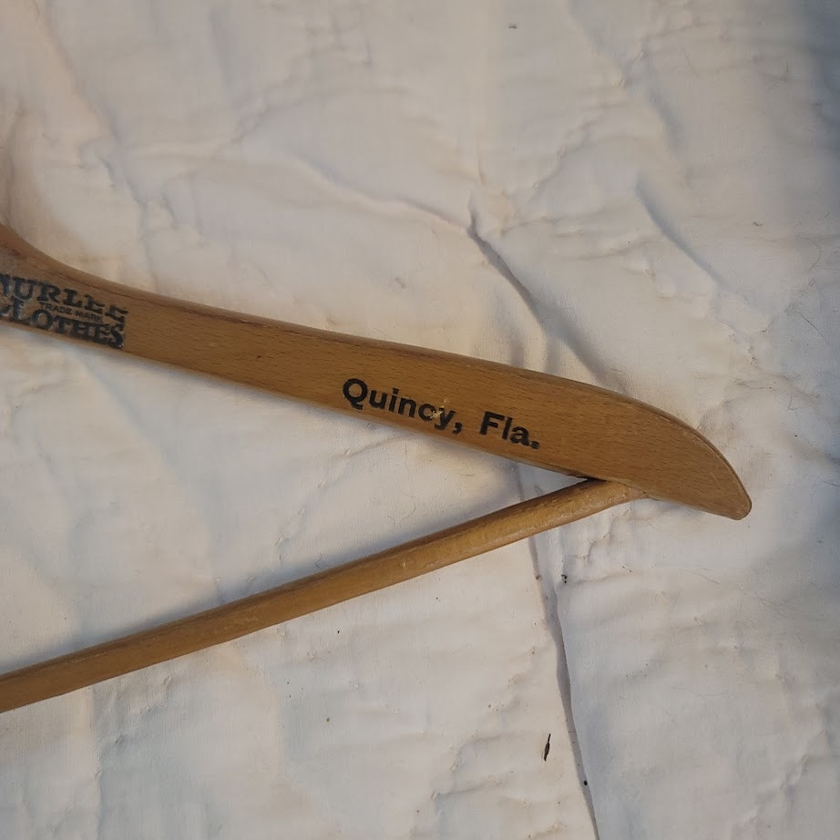 A.L. Wilson Adversting wood clothes hanger Curlee Clothes Quincy, Florida